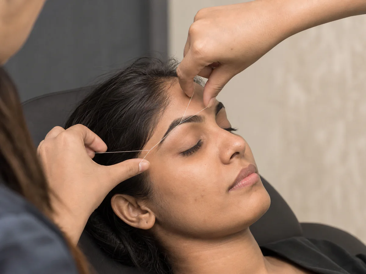 Editorial close-up of a professional eyebrow threading service.