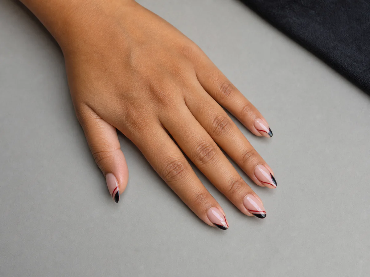 Editorial close-up of refined nail extensions and nail art.